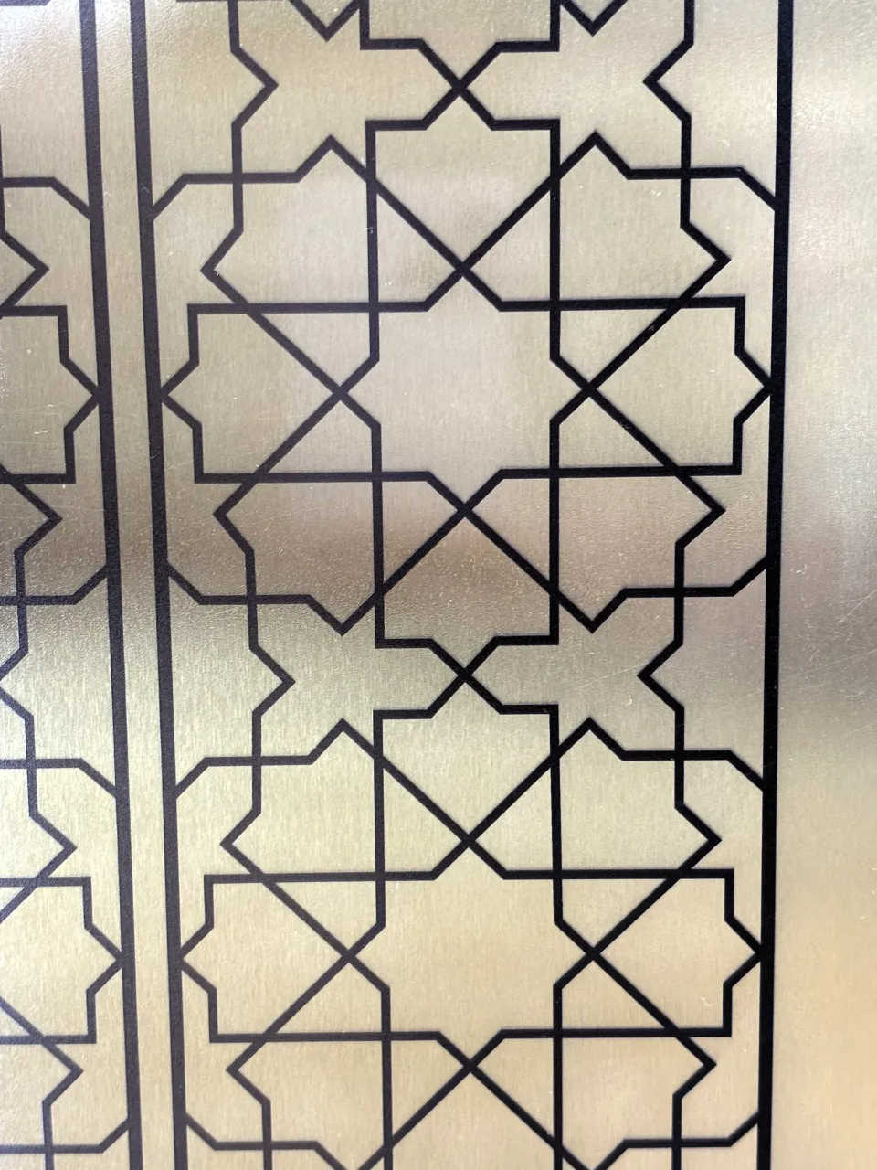 Etched stainless steel sheet with a geometric star pattern