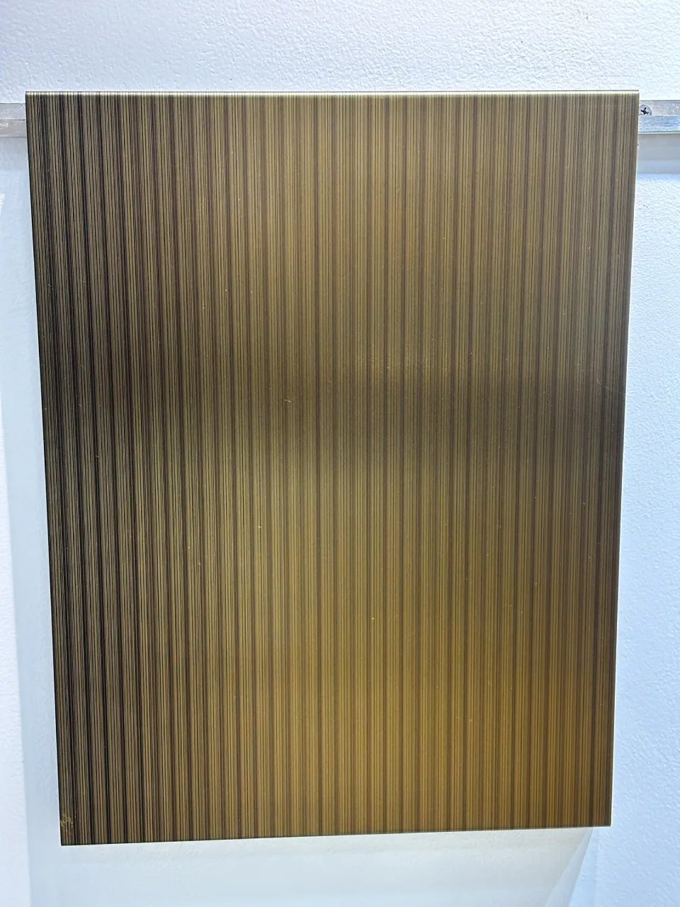 Linear textured stainless steel sheet in a brass tone